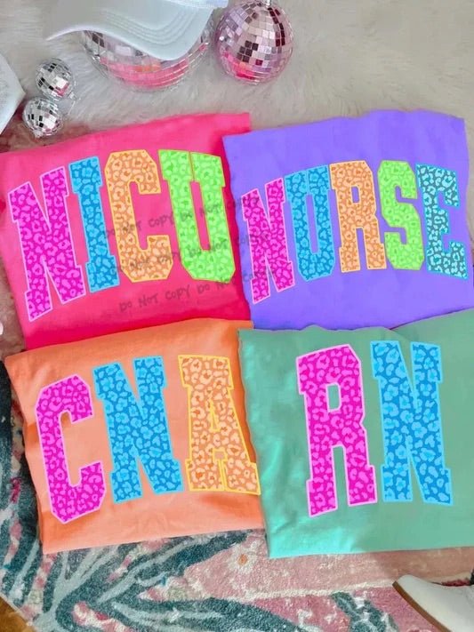 Bright nurse-themed t-shirts with bold letters reading NICU, NURSE, CNA, and RN in neon leopard prints.